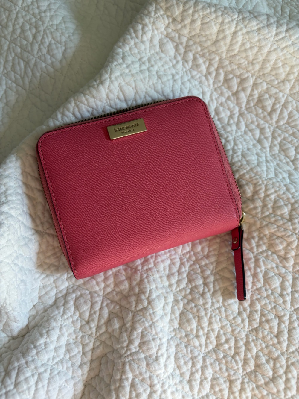 kate spade coral-pink ziparound leather wallet with gold-tone plaque